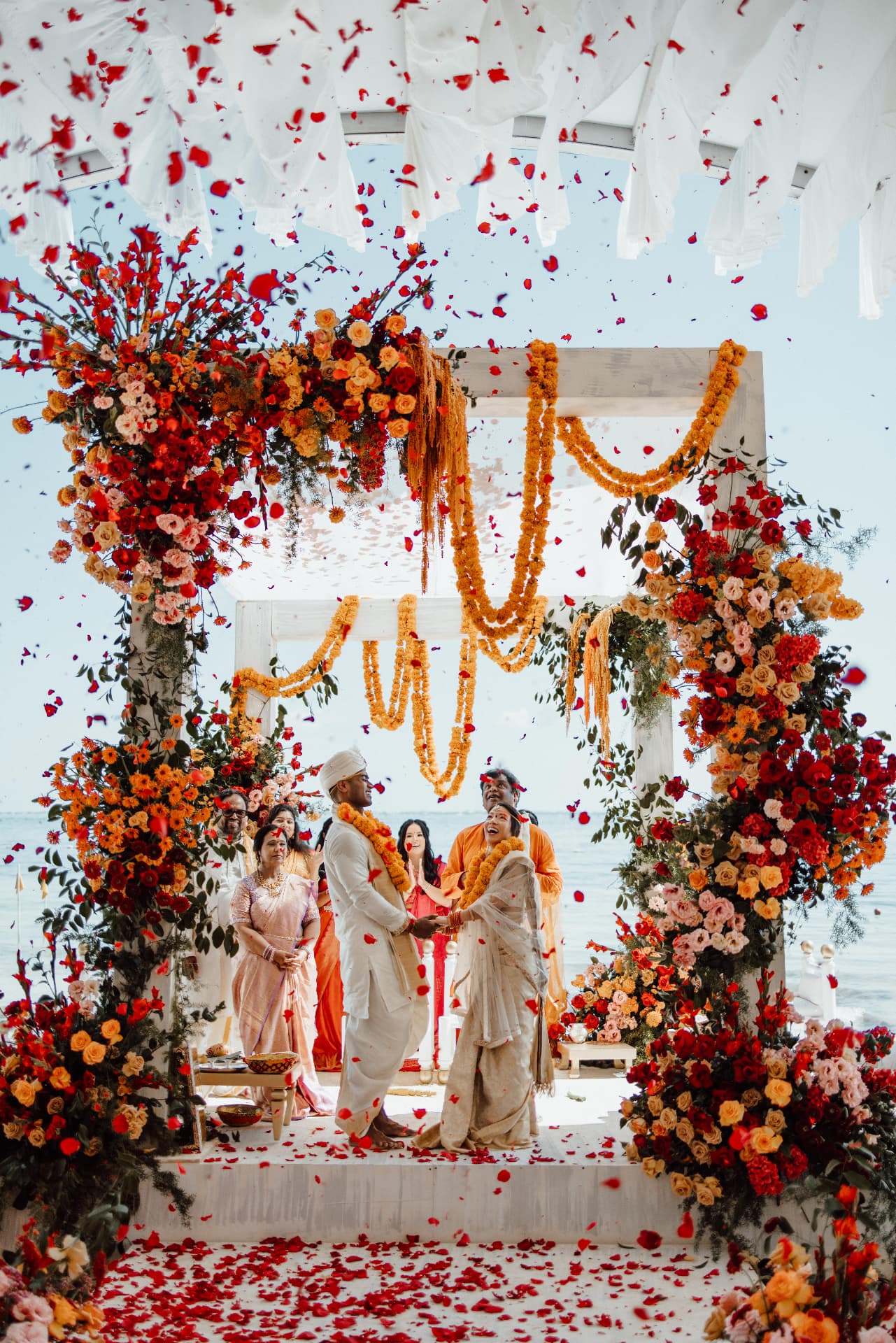 Flower petals falling above a couple during their ceremony